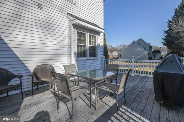 deck featuring grilling area and outdoor dining space