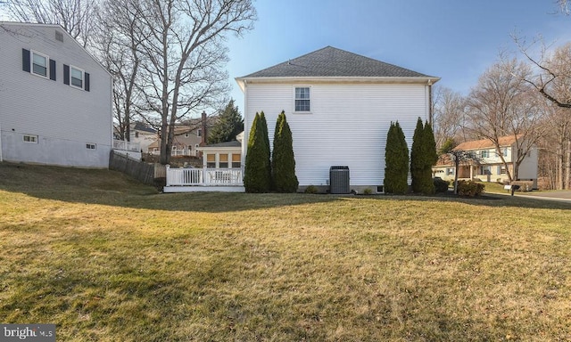 view of home's exterior featuring central air condition unit and a lawn