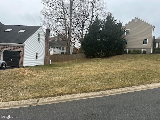 view of yard with fence and a garage