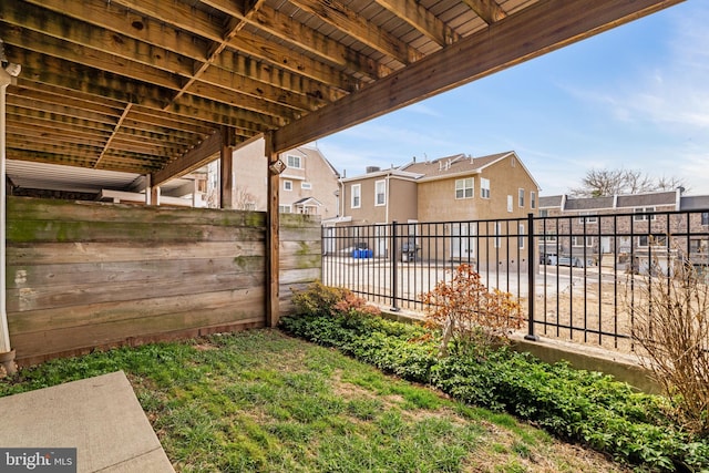 view of yard with a residential view and fence