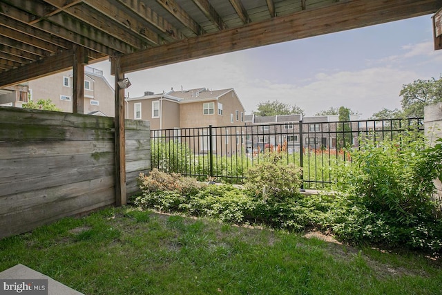 view of yard with a residential view and fence