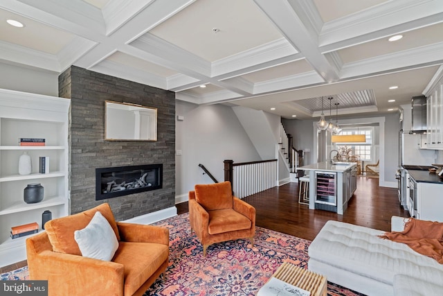 living area featuring beamed ceiling, wine cooler, dark wood-type flooring, and coffered ceiling