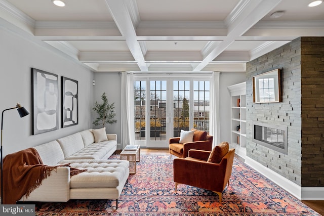 living room with a fireplace, wood finished floors, coffered ceiling, french doors, and beamed ceiling