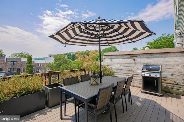 wooden deck featuring outdoor dining area and area for grilling