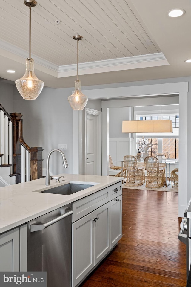 kitchen featuring crown molding, a tray ceiling, dishwasher, and a sink