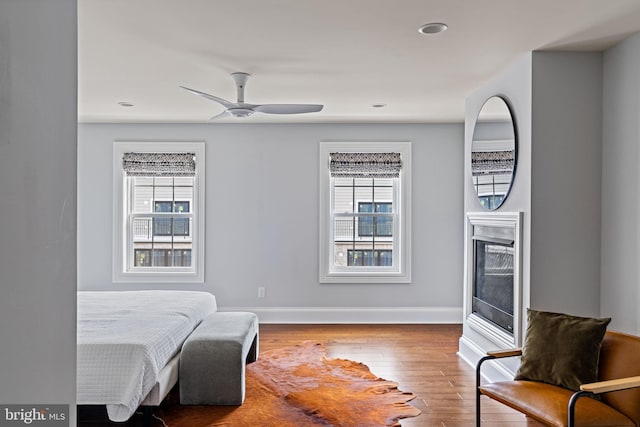 bedroom featuring recessed lighting, wood finished floors, a ceiling fan, and baseboards