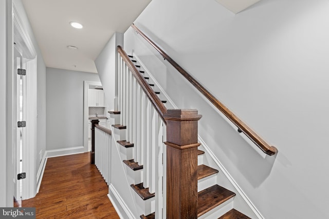 staircase with recessed lighting, wood finished floors, and baseboards