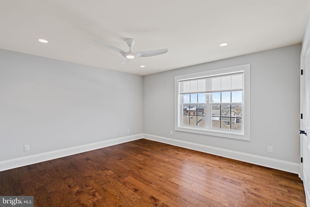 unfurnished room with ceiling fan, recessed lighting, wood finished floors, and baseboards