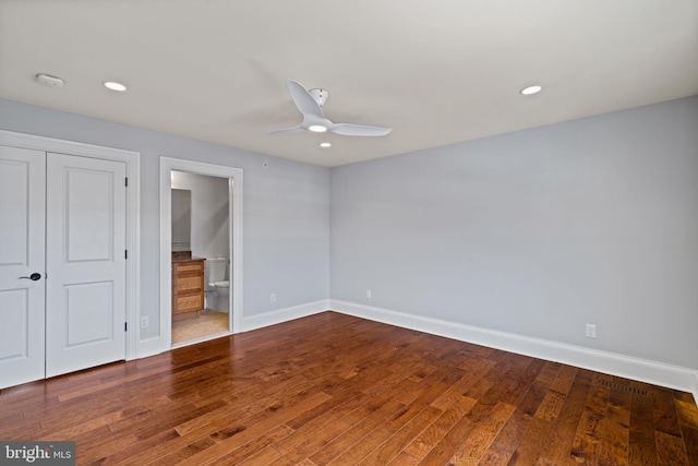 unfurnished bedroom with recessed lighting, wood-type flooring, and baseboards