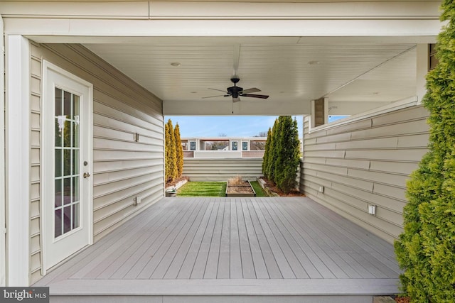 wooden terrace featuring a ceiling fan