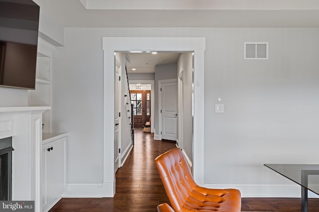 hall featuring baseboards, visible vents, dark wood-style flooring, and recessed lighting