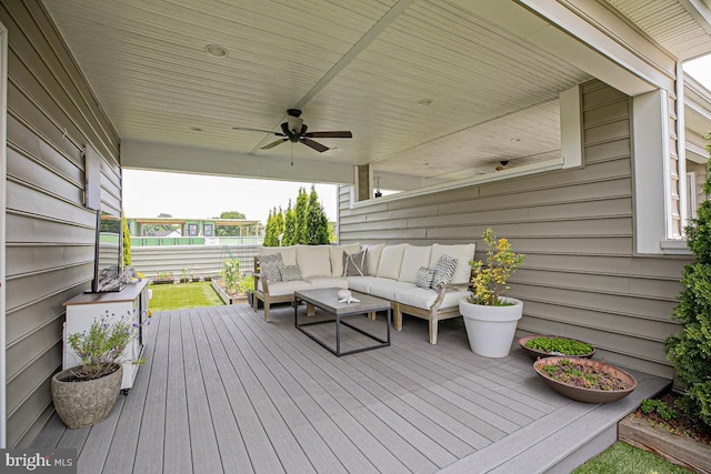 deck with an outdoor hangout area and a ceiling fan