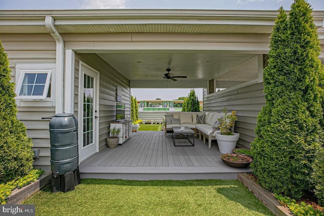 deck with a ceiling fan and an outdoor living space