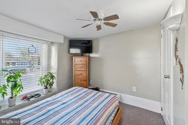 bedroom with ceiling fan and baseboards