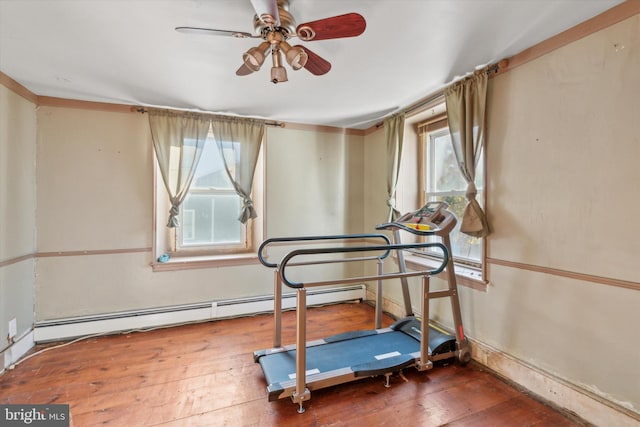 workout room featuring a baseboard radiator, wood-type flooring, and a ceiling fan