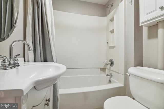 bathroom with shower / bath combination with curtain, vanity, and toilet