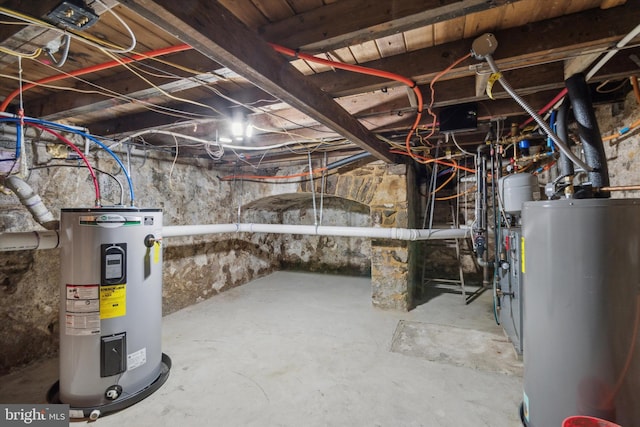 unfinished basement with water heater and electric water heater