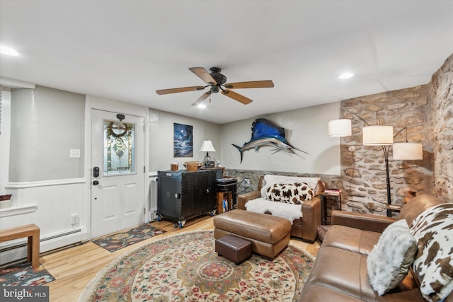 living room with wainscoting, wood finished floors, a ceiling fan, and recessed lighting