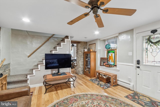 entryway with a baseboard heating unit, recessed lighting, wood finished floors, and stairs