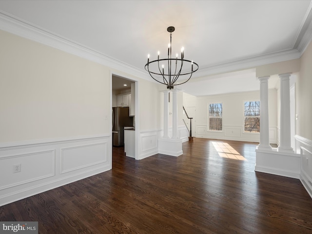 unfurnished dining area with a notable chandelier, dark wood-style flooring, ornamental molding, stairway, and ornate columns