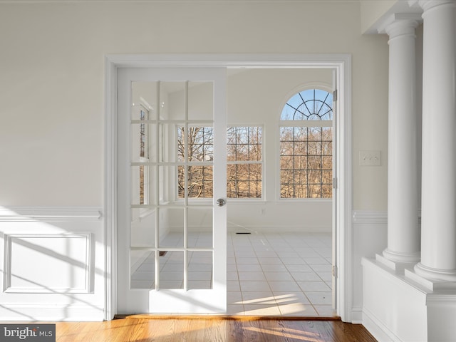 entryway featuring decorative columns and baseboards