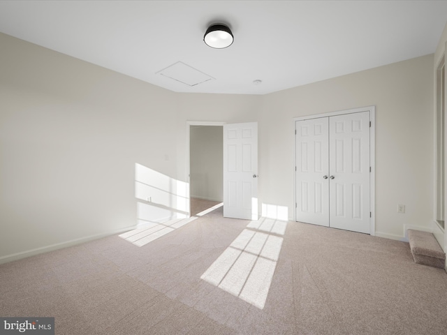 unfurnished bedroom featuring carpet floors, a closet, and baseboards