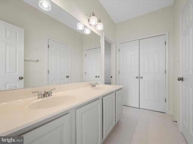 full bathroom with a sink and double vanity