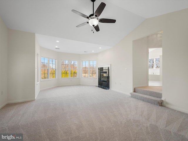 unfurnished living room with recessed lighting, a fireplace, carpet flooring, baseboards, and vaulted ceiling