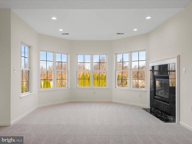 interior space with visible vents and a tiled fireplace