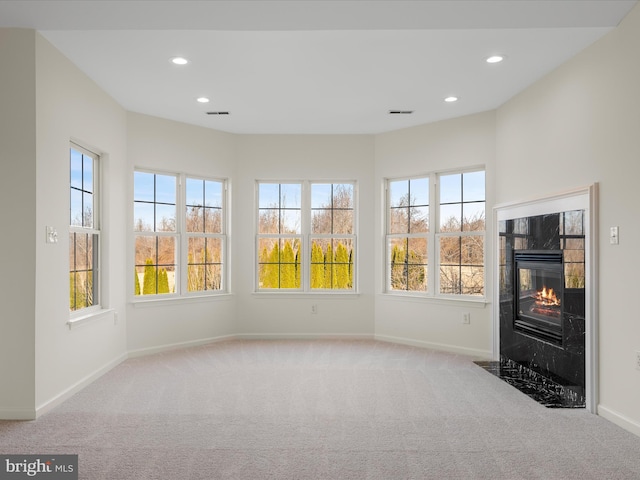 unfurnished sunroom featuring visible vents and a tiled fireplace