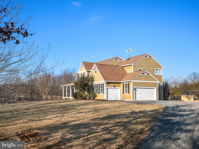 view of side of home with driveway, a yard, and a shingled roof