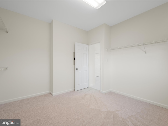 walk in closet with carpet flooring