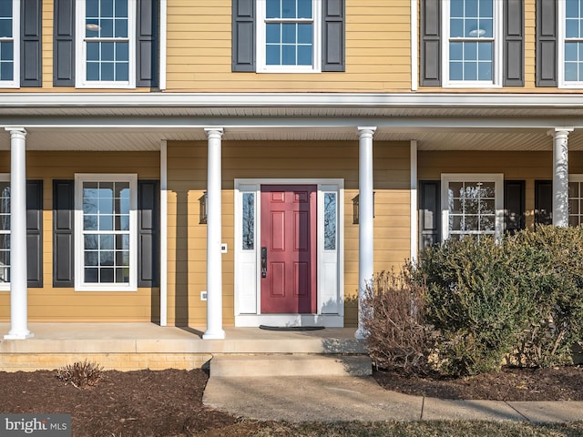 doorway to property featuring covered porch