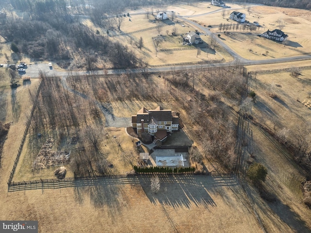 birds eye view of property with a rural view