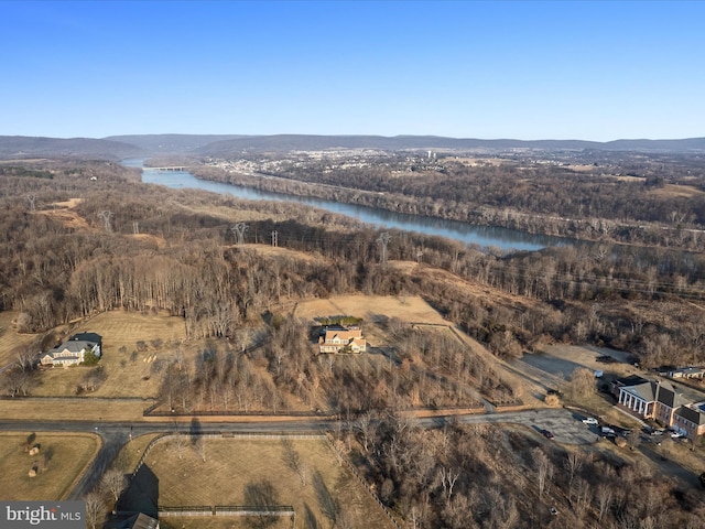 birds eye view of property with a water view and a wooded view