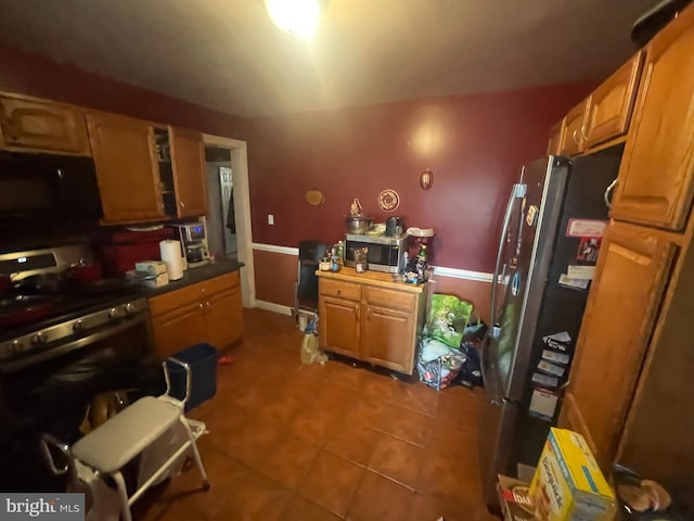 kitchen featuring appliances with stainless steel finishes and tile patterned flooring