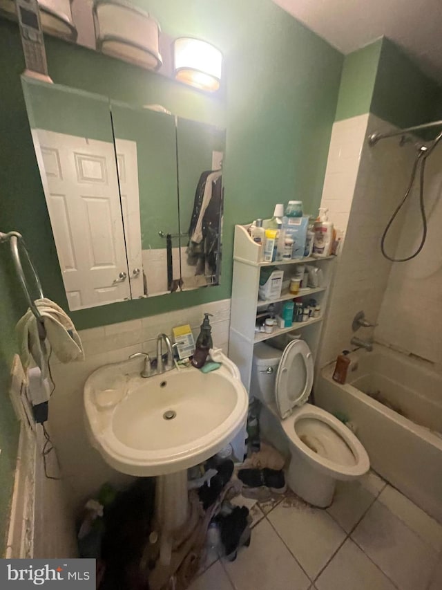 full bathroom featuring toilet, tile patterned flooring, tub / shower combination, and a sink