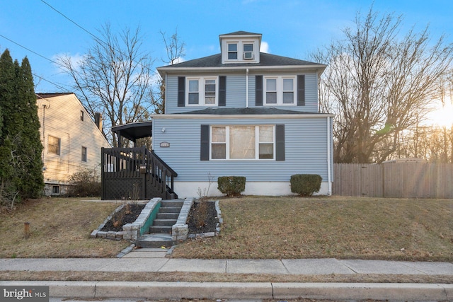 traditional style home with fence and a front lawn