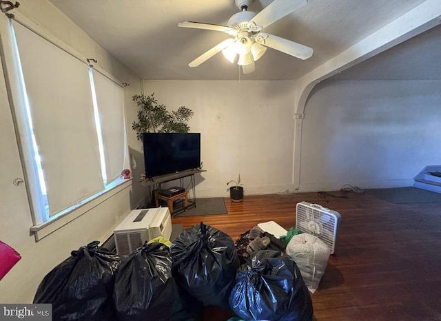 living area with a ceiling fan and wood finished floors