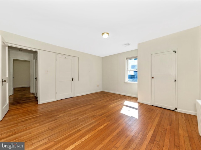 unfurnished bedroom with light wood-type flooring and baseboards