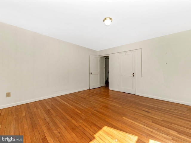 spare room with light wood finished floors and baseboards