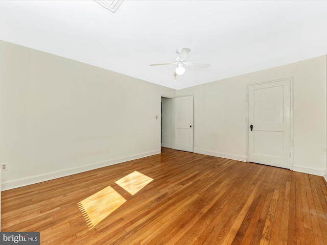 unfurnished bedroom featuring ceiling fan, baseboards, and hardwood / wood-style flooring