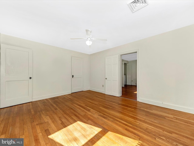 unfurnished bedroom with light wood-style floors, visible vents, baseboards, and a ceiling fan