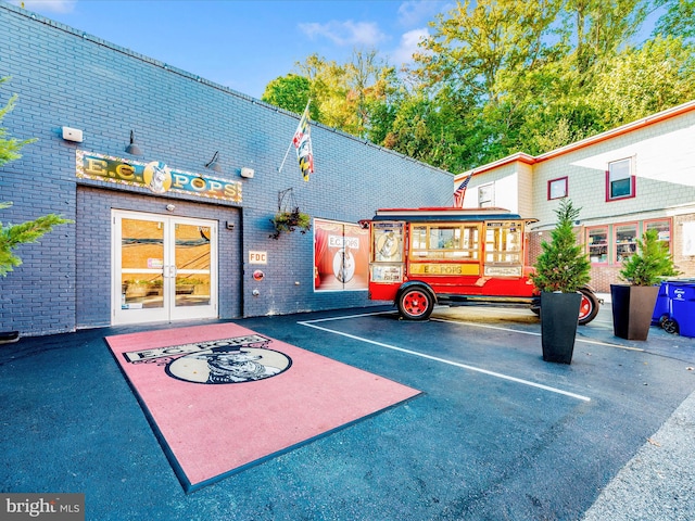 uncovered parking lot featuring french doors