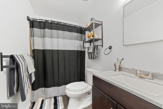 full bathroom with toilet, curtained shower, and vanity