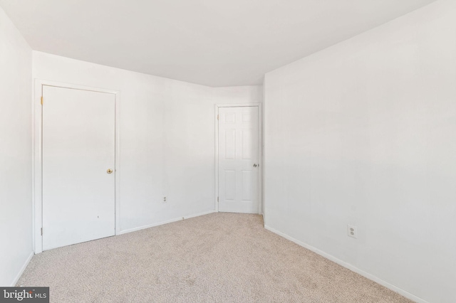 spare room with carpet floors and baseboards