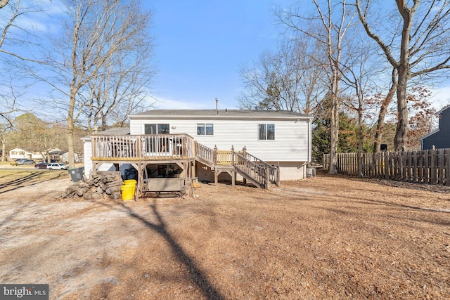 rear view of house featuring a deck, stairway, fence, and central air condition unit