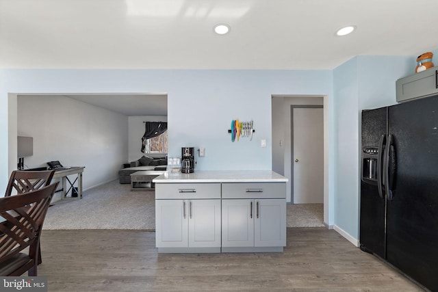 kitchen with light wood-style flooring, gray cabinets, black refrigerator with ice dispenser, light countertops, and recessed lighting