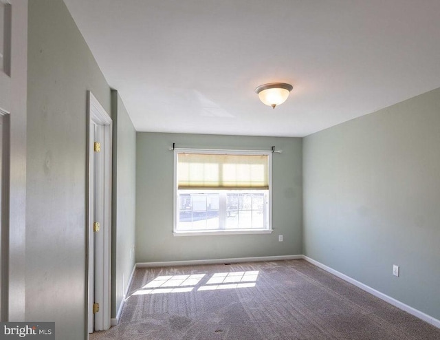 empty room with carpet floors and baseboards