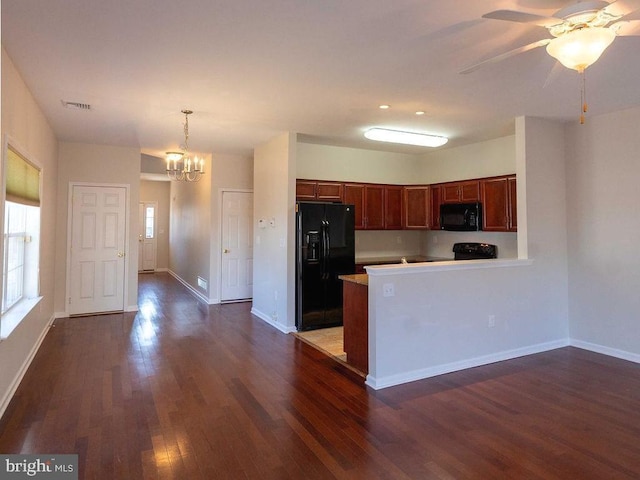 kitchen with dark wood finished floors, light countertops, visible vents, black appliances, and baseboards